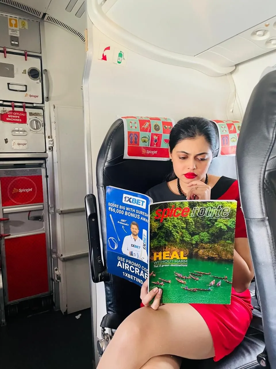 A passenger reading Spice Route in a SpiceJet cabin
