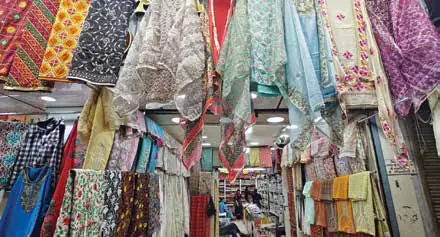 Colourful garments and fabrics hanging in a market