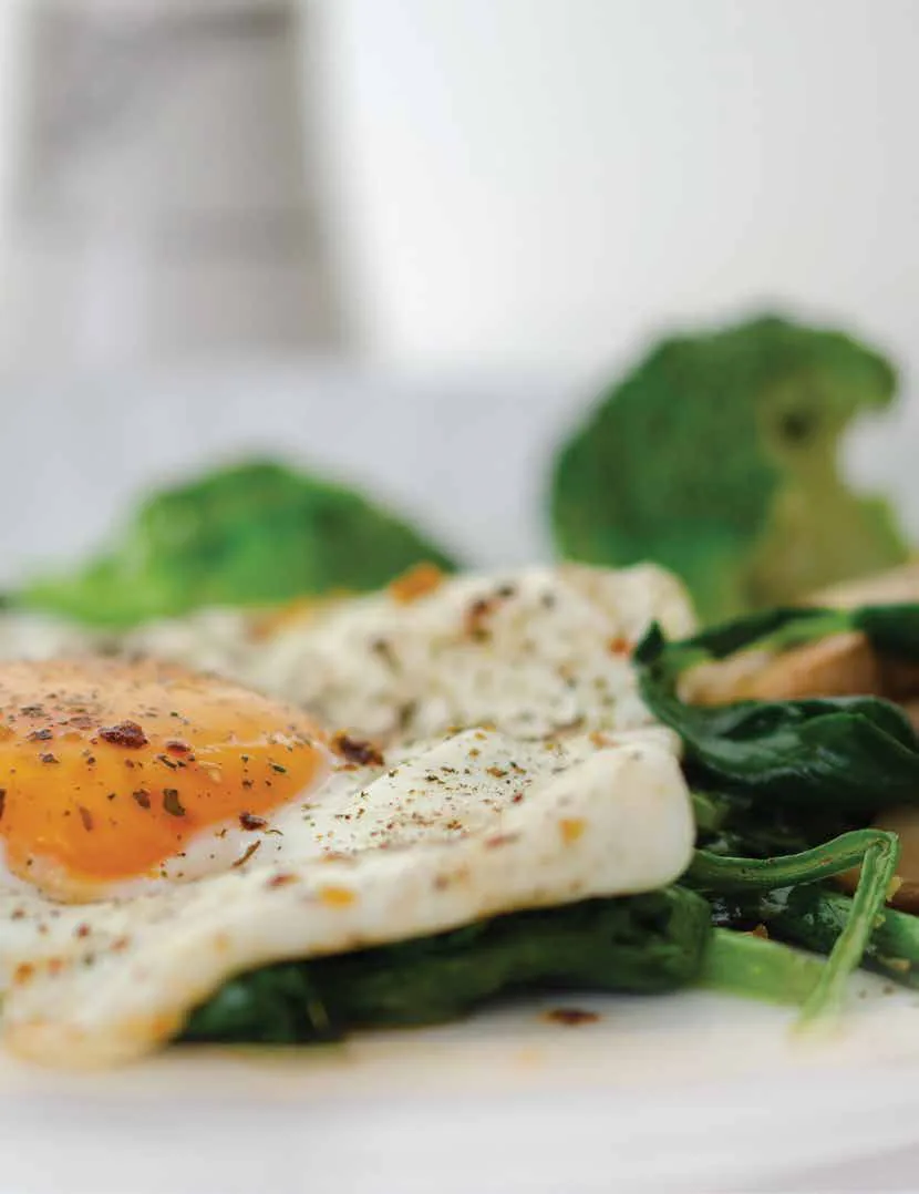 A plate of eggs with sautéed greens