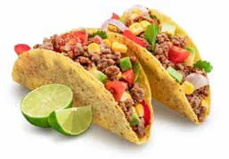 Tacos filled with spiced mince and tomato, with lime wedges