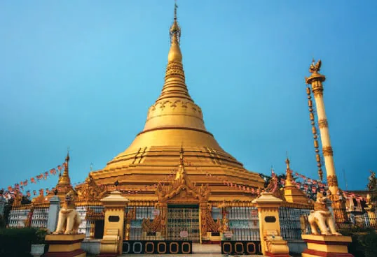 A golden stupa under a blue sky