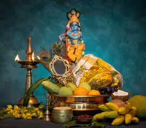 A festive arrangement of fruit, flowers and a lamp before an idol