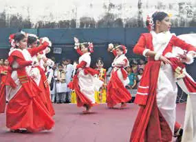 Dancers in red and white costumes performing in a row