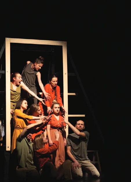 Actors performing on a dark stage