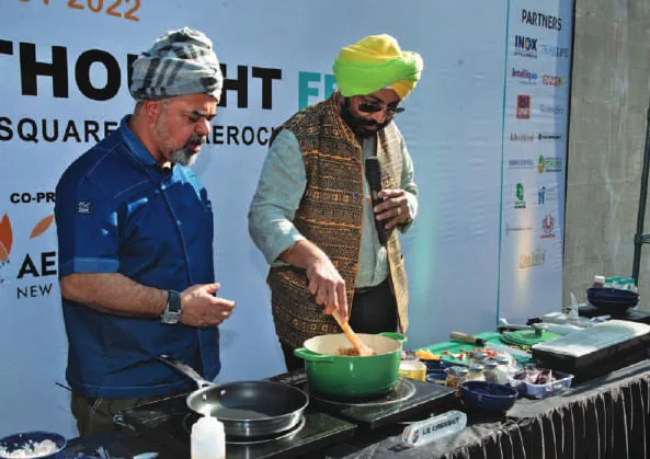 Chefs cooking at a food festival stall