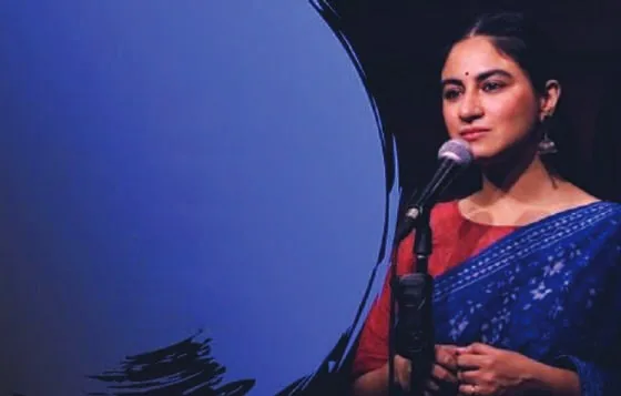 A woman performing spoken-word poetry on stage