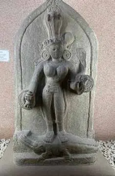 A carved stone sculpture of a goddess in a museum