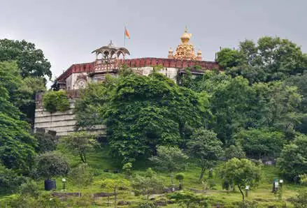 A hilltop fort surrounded by trees
