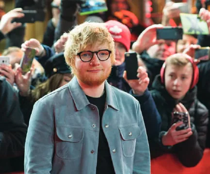 Ed Sheeran in a denim jacket among fans