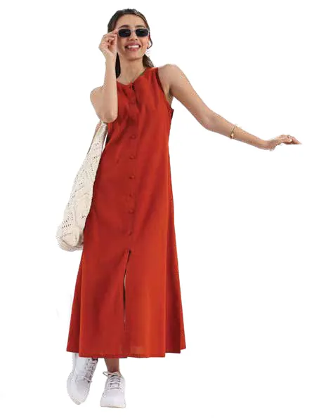 A model in a sleeveless rust-red maxi dress and white sneakers