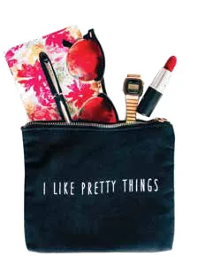 A black pouch holding sunglasses, a lipstick, a watch and a notebook