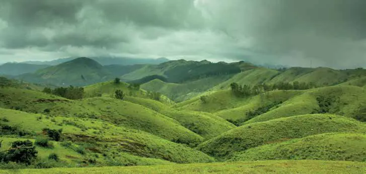 Rolling green hills under a cloudy sky