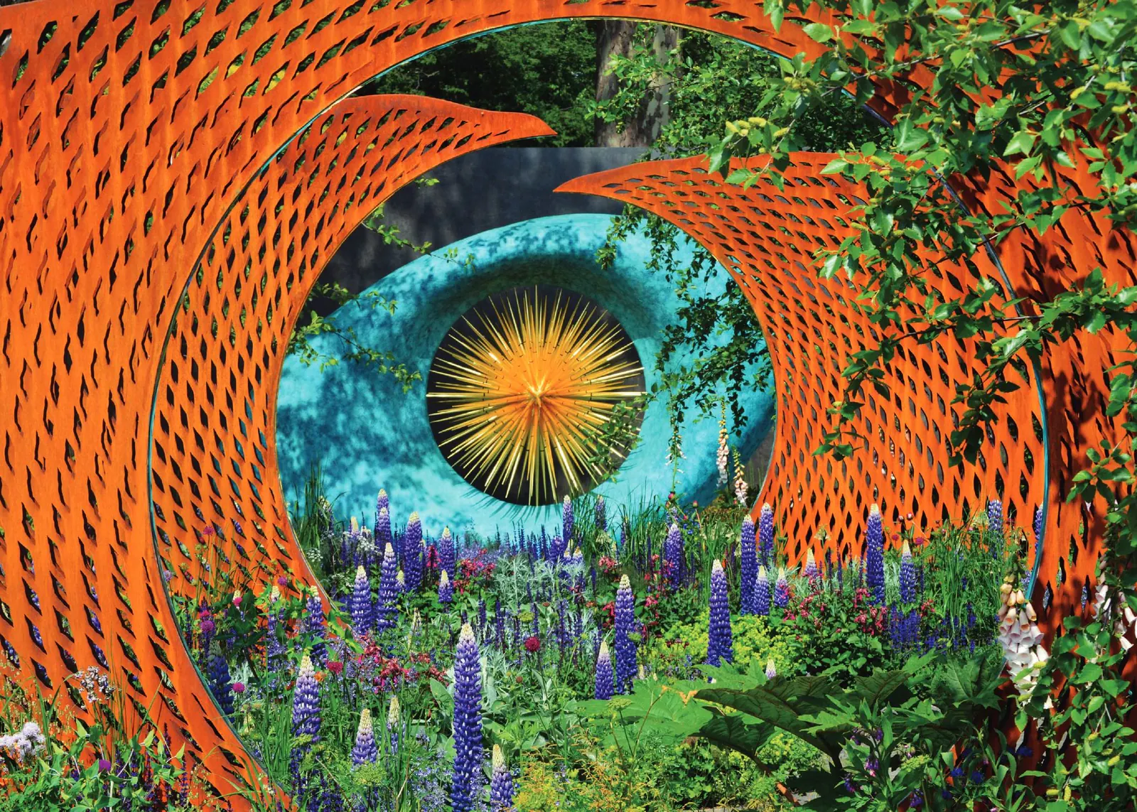 A giant sculpted eye made of orange blooms in a flower show garden