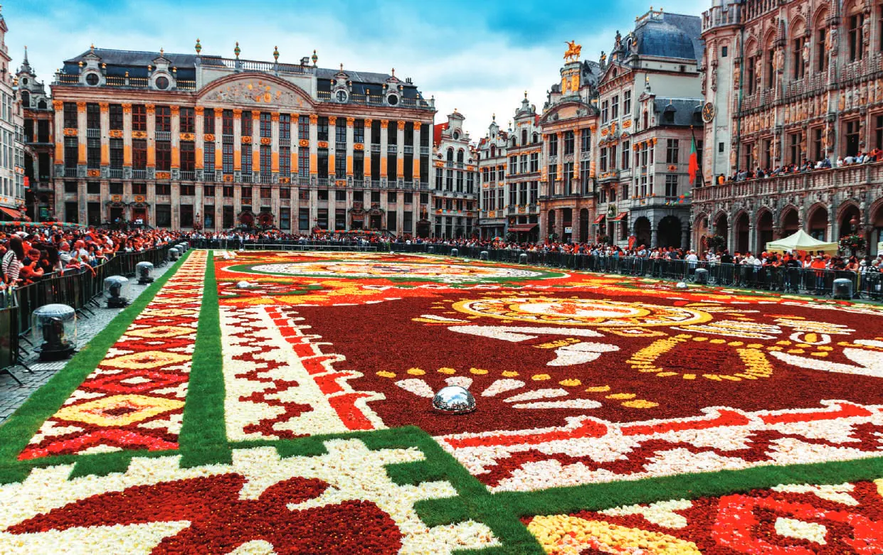 A huge carpet of flowers laid out in a historic square