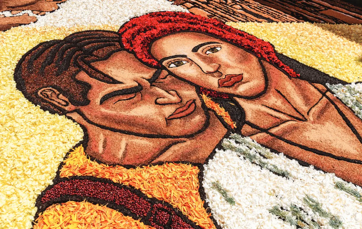 A portrait made of flower petals laid on a street