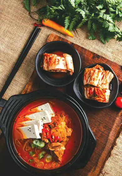 A Korean meal of kimchi and tofu stew seen from above
