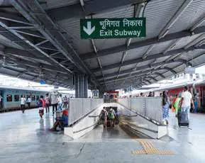 A railway platform with passengers and an exit sign