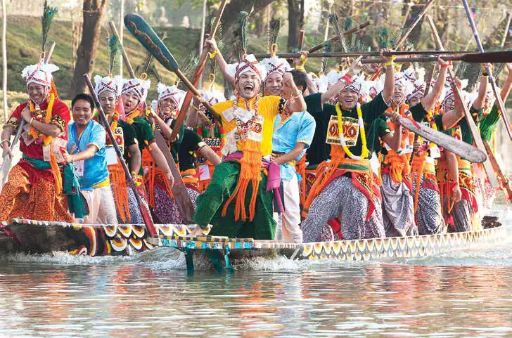 Rowers in traditional dress racing long boats