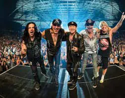 The band Scorpions on stage in front of a large crowd