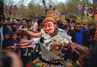 A masked dancer performing before a crowd
