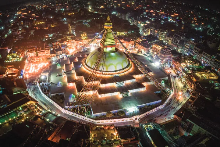A stupa illuminated at night