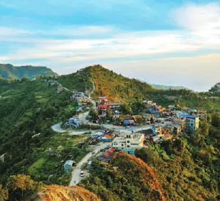A town spread over forested hills