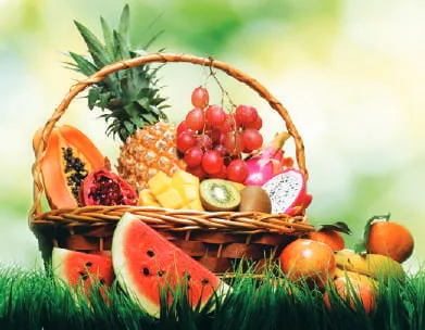 A basket of fruits including watermelon and mangoes