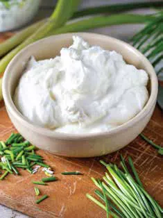 A bowl of curd with chopped chives