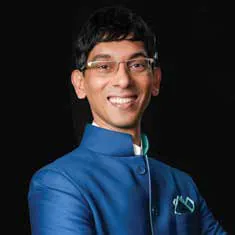 Portrait of a smiling man in glasses and a blue jacket