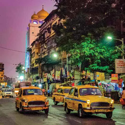 Yellow taxis on a busy street at dusk