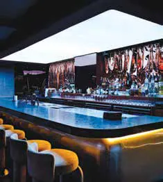 A long, backlit bar counter in a restaurant
