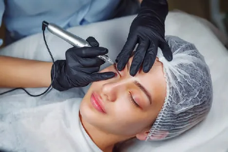 A technician applying lip pigment