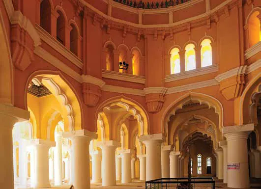 Arched halls and columns inside a palace, lit in warm light