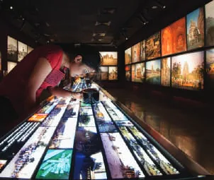 Visitors at an illuminated interpretive display