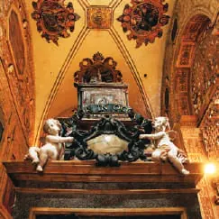 An ornate gilded tomb inside a church
