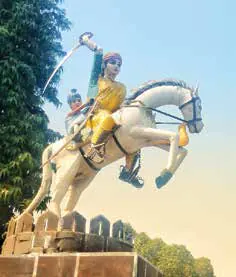 A statue of a rider on a rearing white horse
