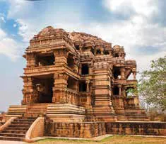 An ornately carved stone temple under a blue sky
