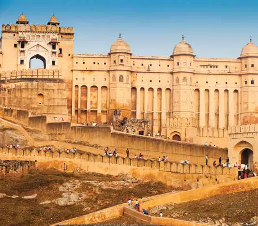 A sandstone fort and palace complex under a blue sky