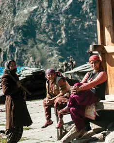 Local residents sitting and chatting on the porch of a wooden house