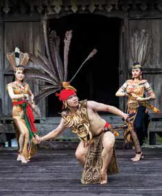 Dancers in feathered headdresses performing a traditional dance