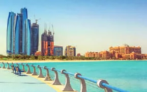 A city skyline across turquoise water