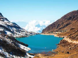 A turquoise lake among snowy mountains