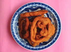 Rings of sel roti in a bowl