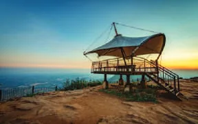 A pavilion on a hilltop at sunrise