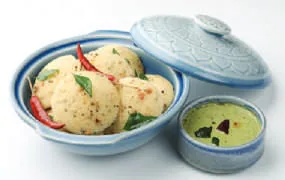 Idlis in a steamer with chutney