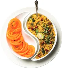 Poha and jalebi served together on a plate