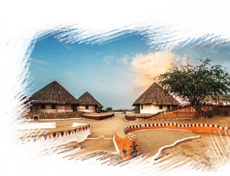 Round thatched huts on sandy ground under a sunset sky, framed by a painted border