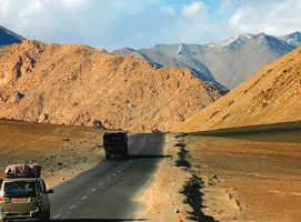 A road winding through a barren mountain valley