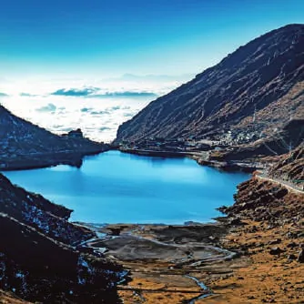 A blue glacial lake below mountains