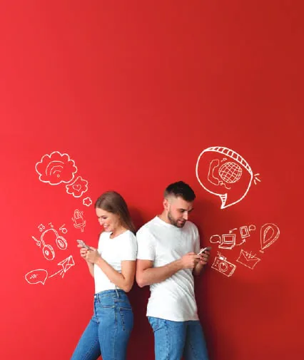 A couple leaning against a red wall with doodles